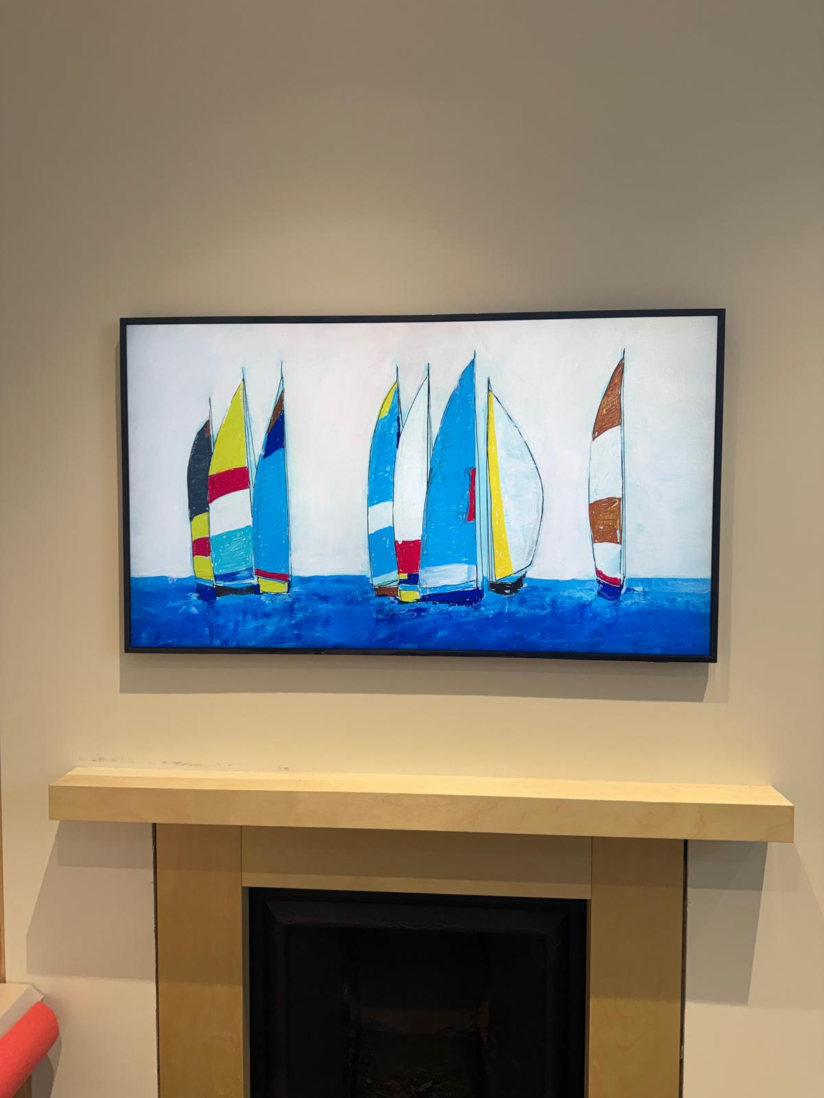 Wall-mounted television displaying artwork above a stone fireplace
